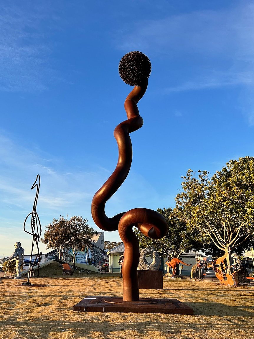 A long metal sculpture on the foreshore.