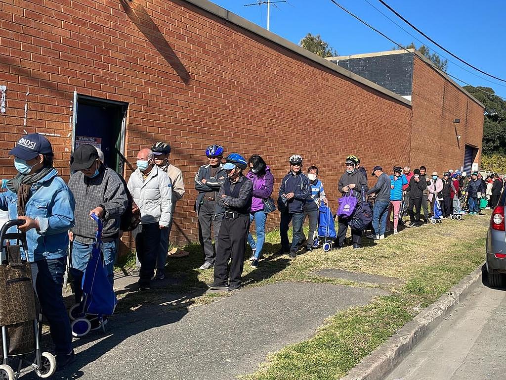 People queue to receive food parcels in Clyde, Sydney. Supplied