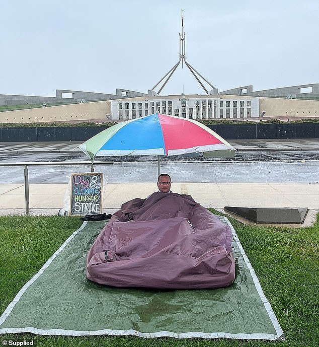 Pictured: Gregory Andrews outside Parliament House, in the rain, on Thursday morning