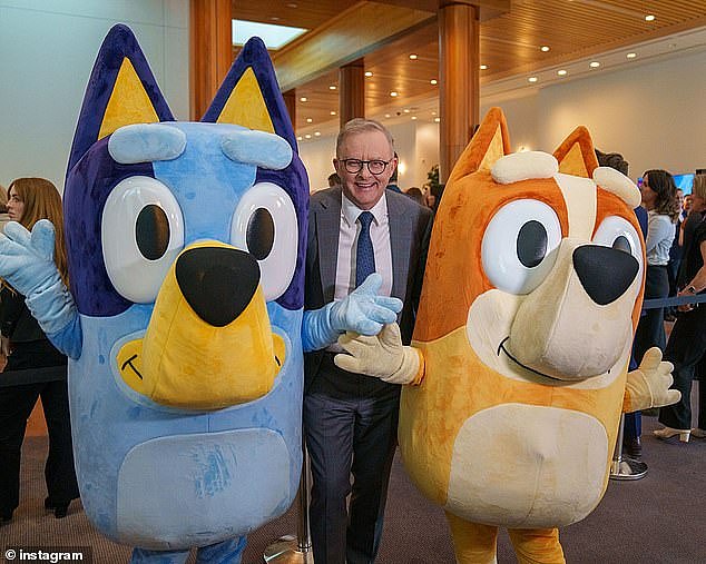 Anthony Albanese has been slammed as 'tone-deaf' for posing with characters from the TV show Bluey while innocent children lose their lives in Gaza (pictured)