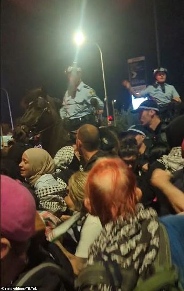 The group, which were protesting an Israeli shipping company, gathered at Port Botany, 12km south of Sydney 's CBD, on Tuesday night (pictured)