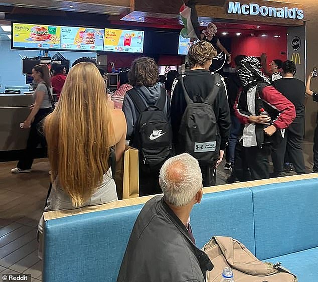 A shocked onlooker claimed a male standing on the McDonald's counter swore at the store manager who asked him to get down