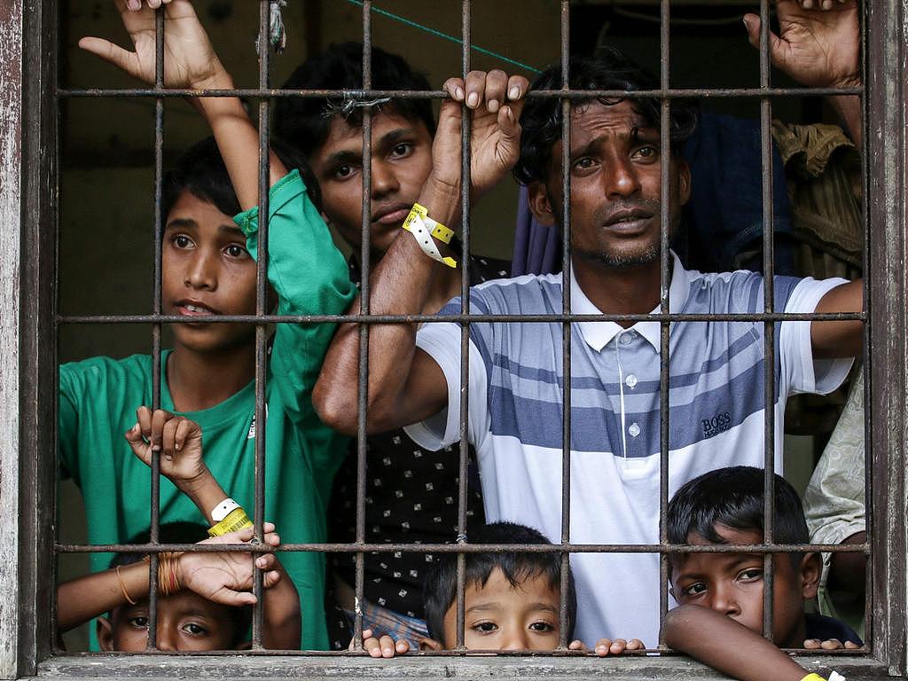Rohingya refugees looking on from their shared quarters at a temporary Indonesian immigration shelter in Lhokseumawe, Aceh province. Picture: AFP