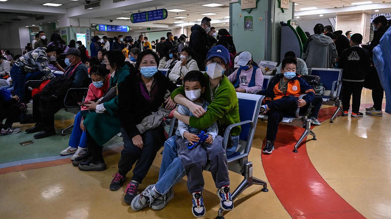 Children and their parents wait in an outpatients area of a Beijing hospital. Picture: AFP