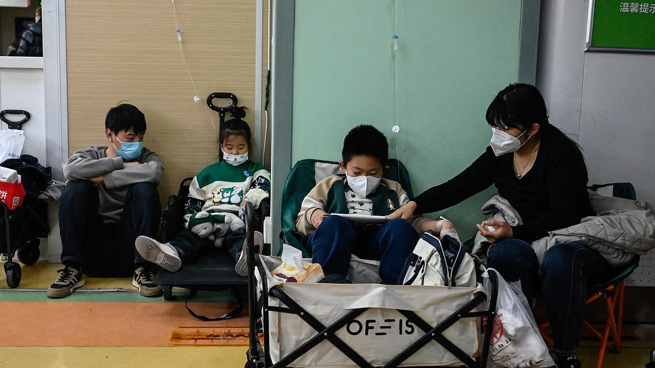 Children are treated on the floor of a children’s hospital in Beijing. Picture: AFP