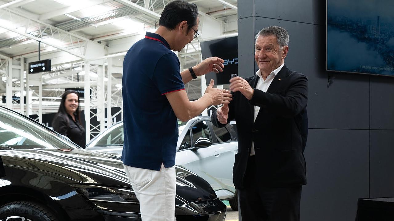 BYD Asia Pacific head of sales, Liu Xueliang, hands over the BYD Seal to Sydney Roosters chairman and leading car industry executive Nick Politis.