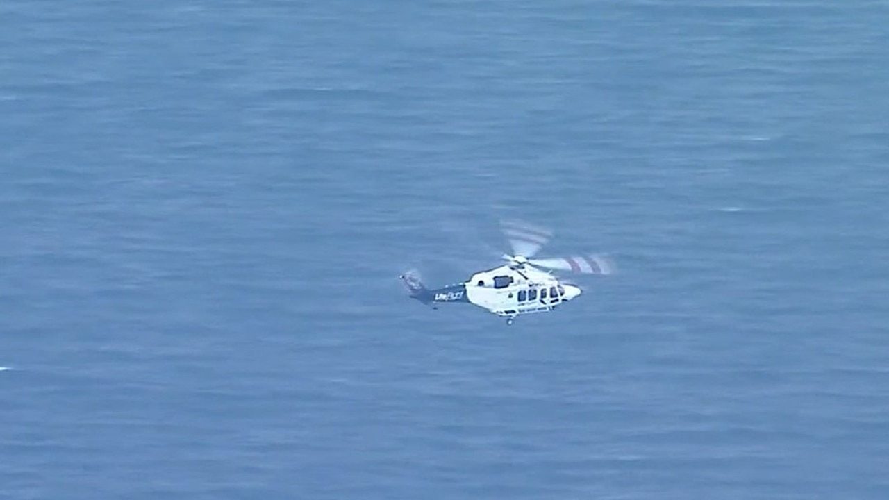 An RACQ Lifeflight helicopter flying Mr Taylor to hospital from the island. Picture: Supplied / Channel 9