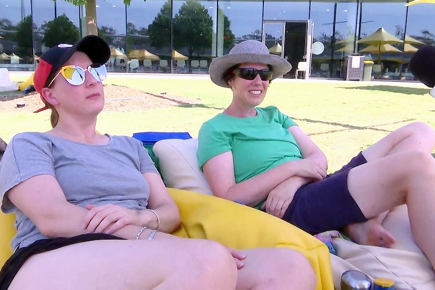 two women at parramatta aquatic centre sitting on beanbangs and wearing glasses
