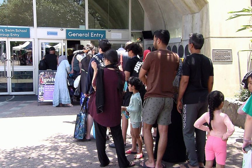 Crowds outside Sydney Olympic Park Aquatic Centre waiting to get in amid nsw heatwave
