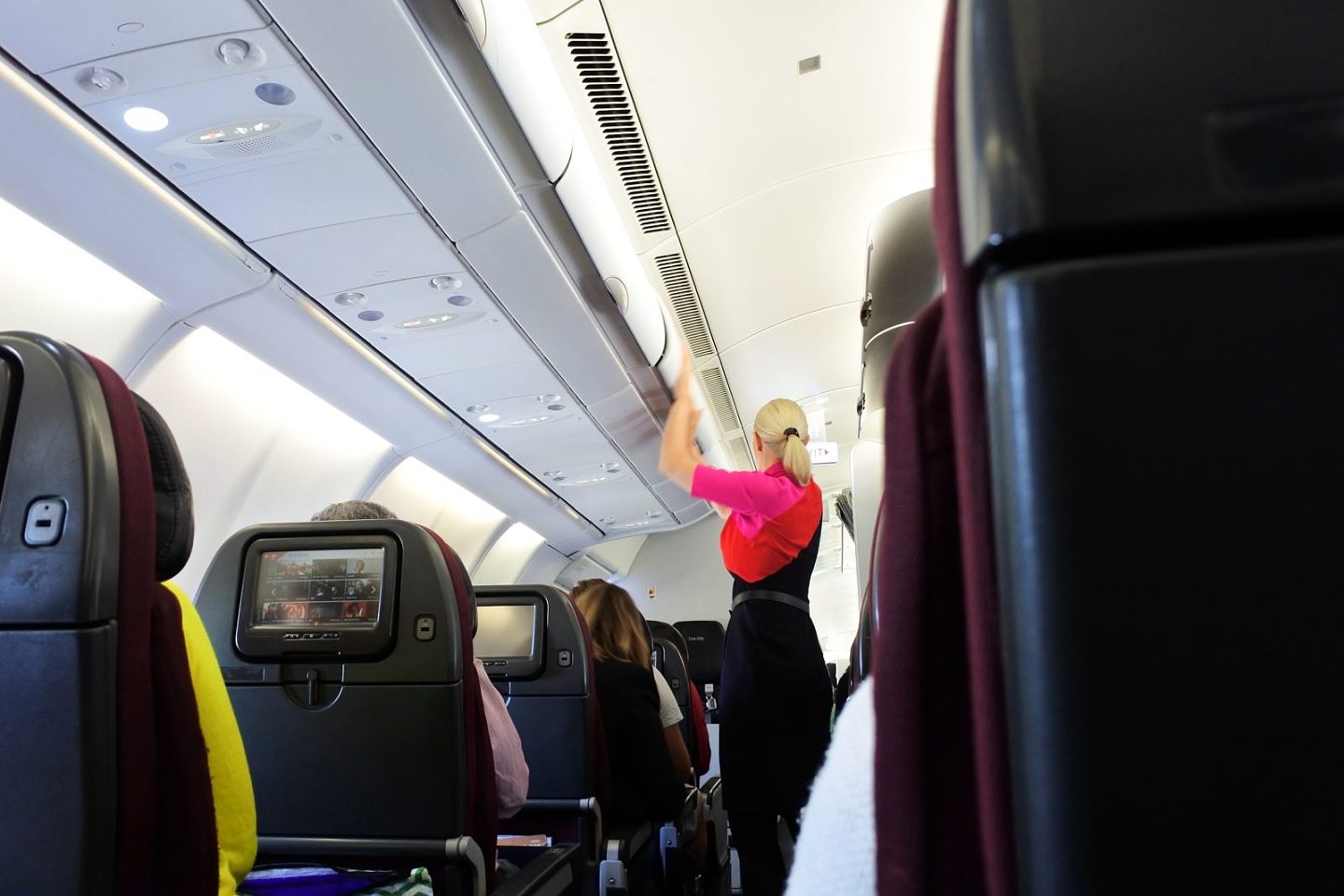 a woman standing in an airplane