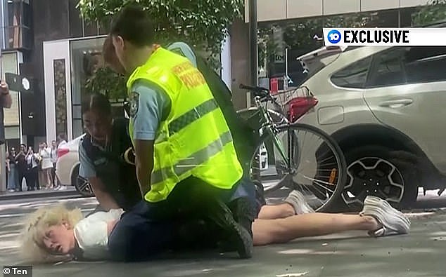 Footage captured the 27-year-old woman ramming several cars in gridlocked traffic on King Street in Sydney 's CBD on Monday, before cops leapt into action