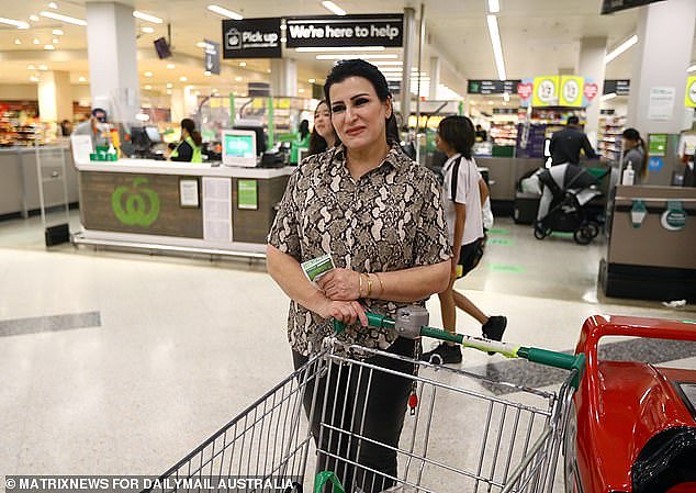 Aussies are seeing the cost of essentials such as groceries soar. Stock image of a woman at Woolworths