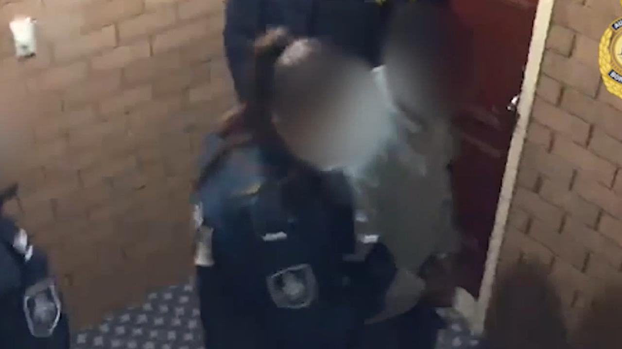 Screenshot from footage of arrests in the impersonation scam. Source: Australian Federal Police