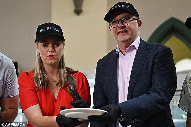 Daily Mail Australia reviews Prime Minister Albanese's promises - those kept, broken and up in the air in 2023. Above, with partner Jodie Haydon serving food to the homeless at Christmas