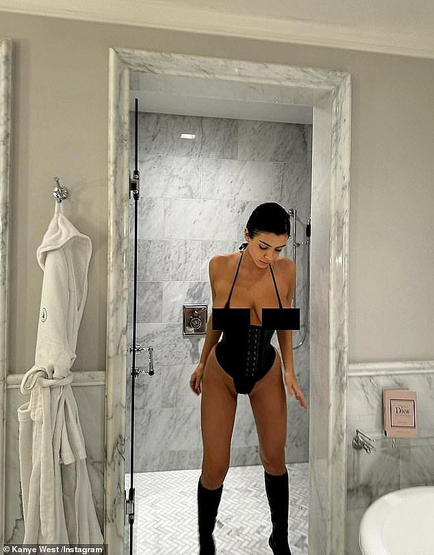 He also posted a picture of her walking out of the shower of lavish hotel room, looking down at her feet dressed in black, knee-high boots and nearly spilling out of her tiny outfit
