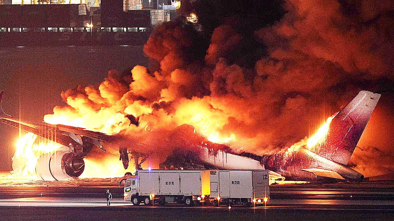 A Japan Airlines plane was in flames on the runway of Tokyo's Haneda Airport on January 2 after colliding with a coast guard aircraft. (Photo by JIJI PRESS / AFP)