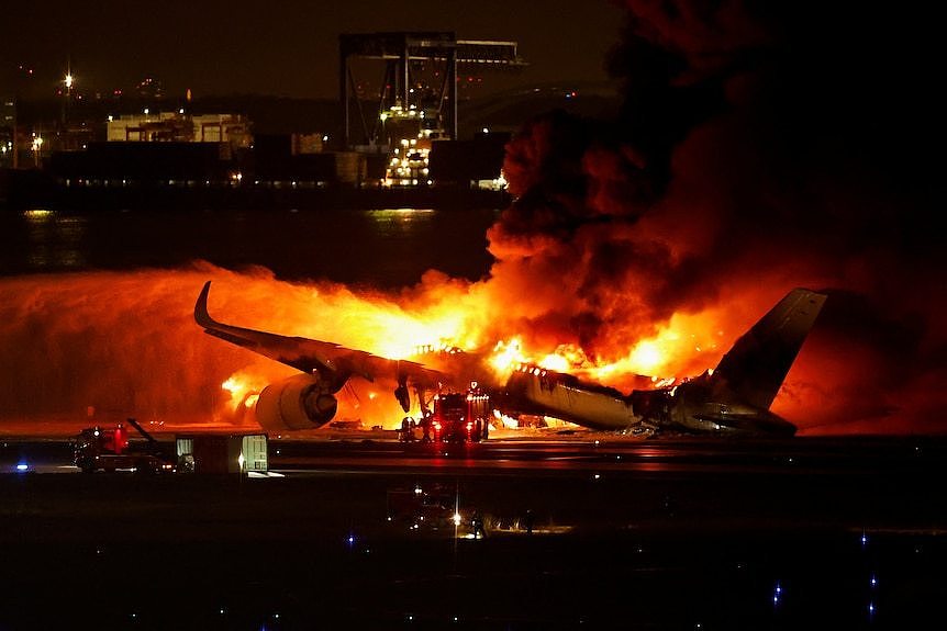 Plane engulfed in flames at nightfall 