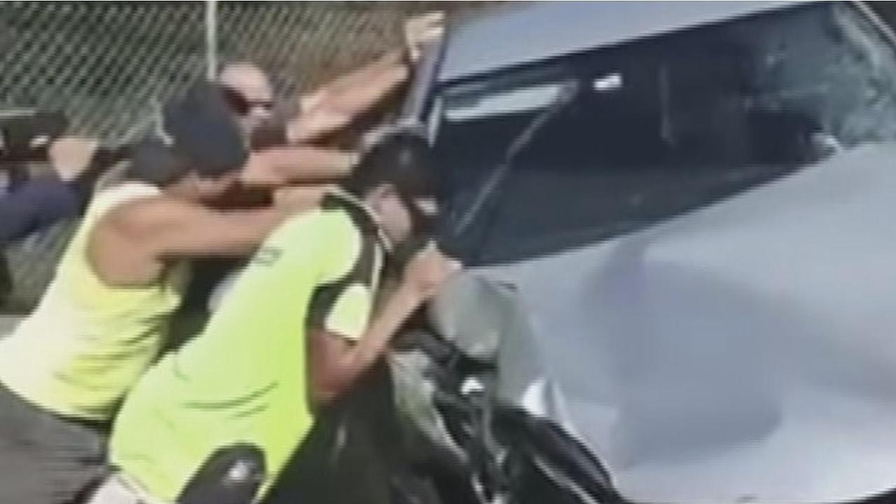 A group of tradies helped right a turned over vehicle. Photo: 9 News