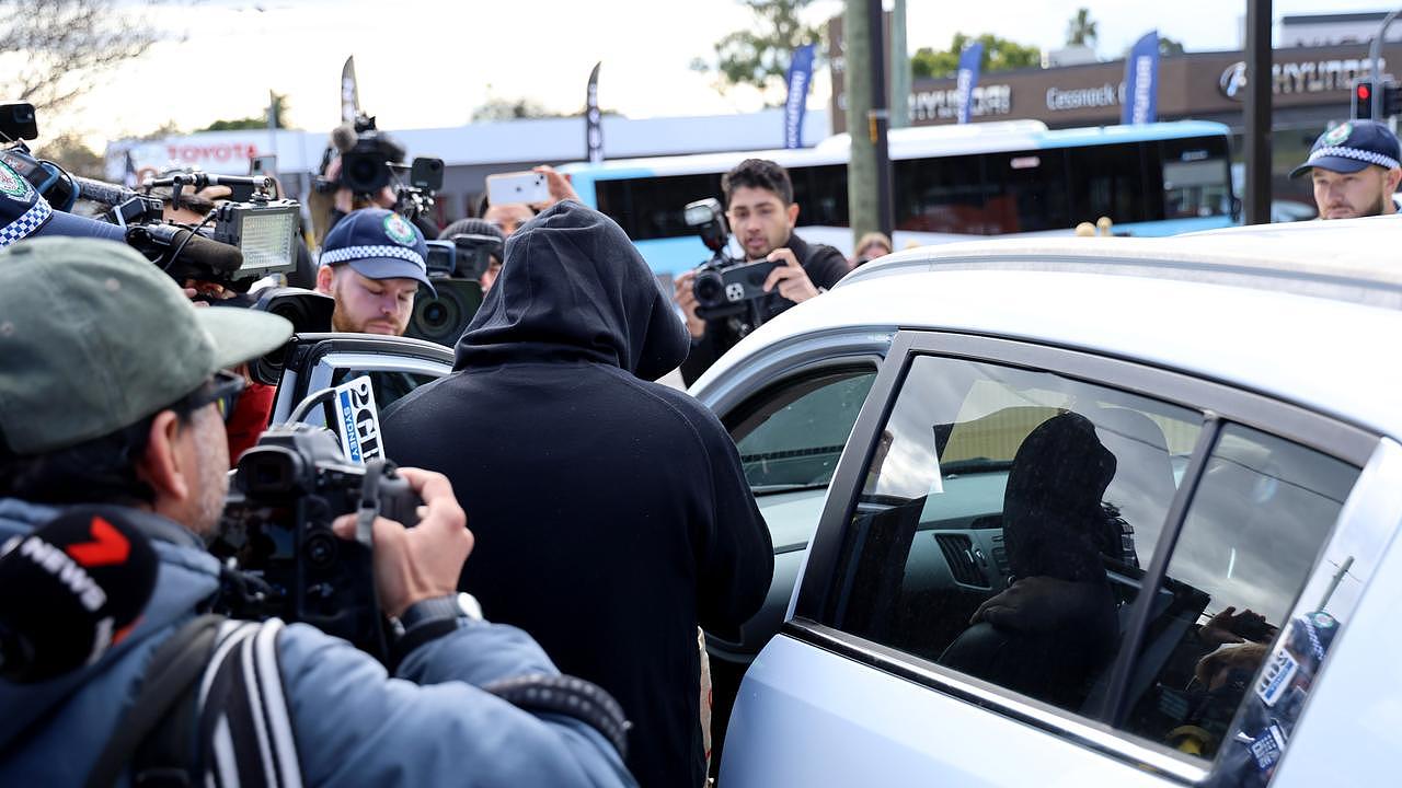 SYDNEY, AUSTRALIA - NewsWire Photos JUNE 13, 2023: Brett Andrew Button pictured getting into a car with the waiting media around it after walking out of Cessnock police station after being granted bail. Picture: NCA NewsWire / Damian Shaw
