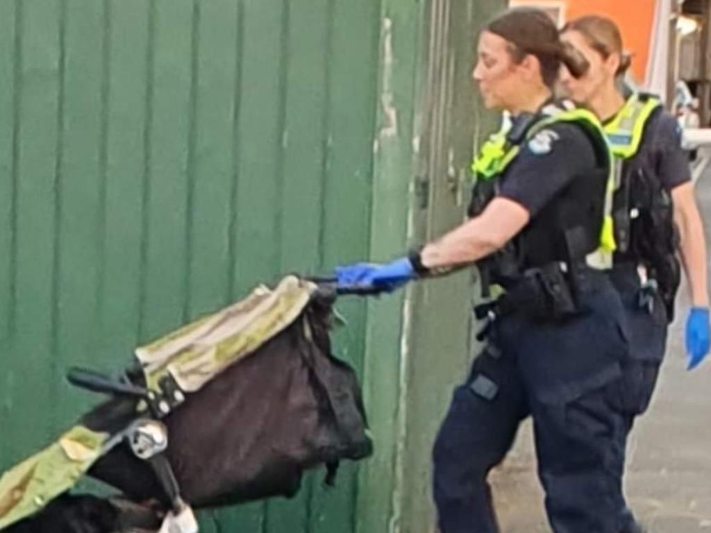 Police officers remove a pram after a small child was found outside the safe injecting room in North Richmond on Australia Day. Picture: Facebook.