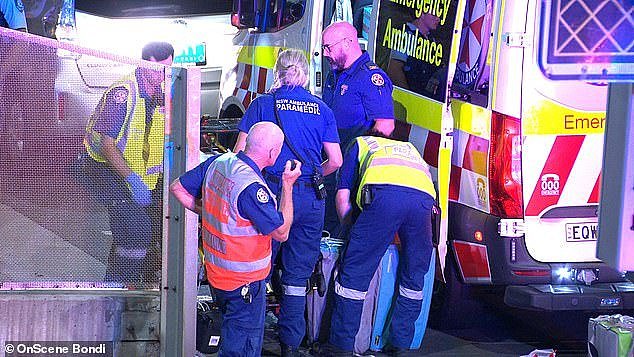 The e-bike rider (pictured surrounded by paramedics) remains in a critical condition