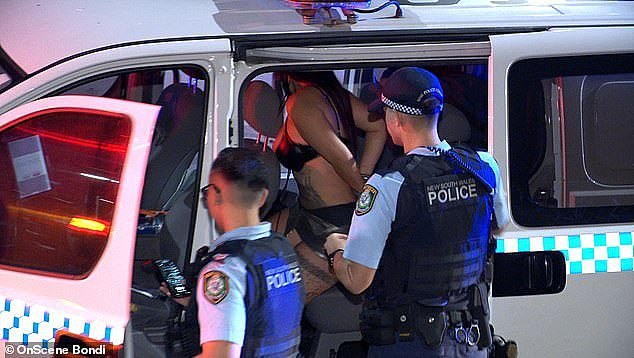 Cindy Pham (pictured in the back of the police van) allegedly returned a positive breath test at the scene of the crash