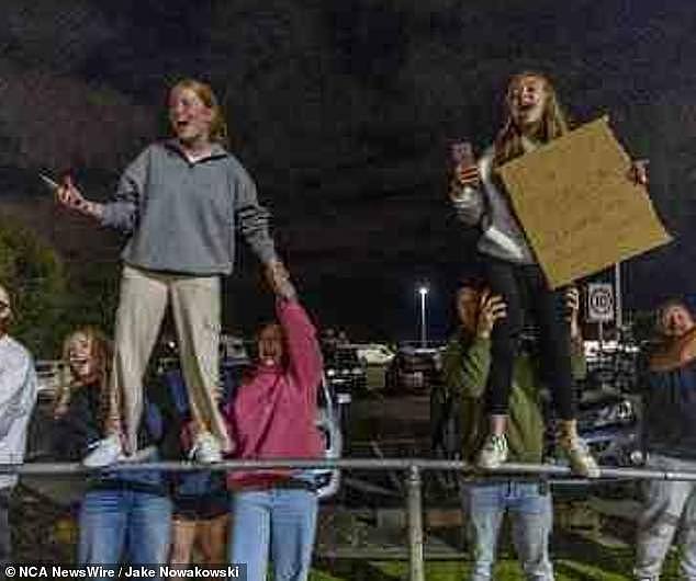 The group of dedicated fans waved banners, snapped photos and cheered as the 34-year-old megastar touched down in her private jet at 1am on Thursday (pictured)