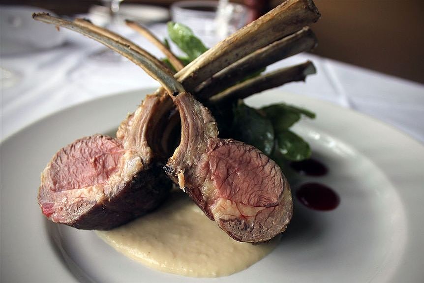 A rack of lamb on a plate