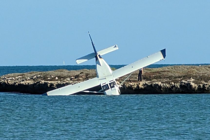A plane nose down in water.