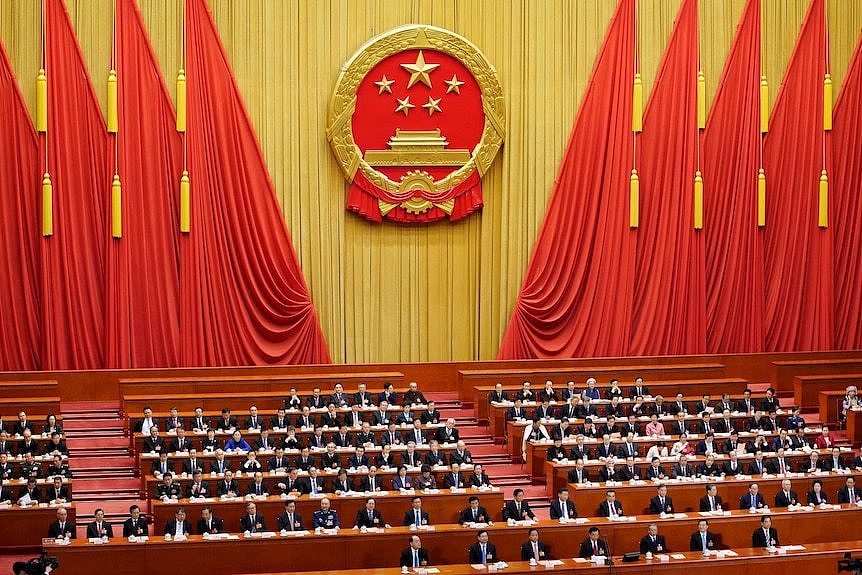 Delegates attend the third plenary session of the National People's Congress at the Great Hall of the People in Beijing.