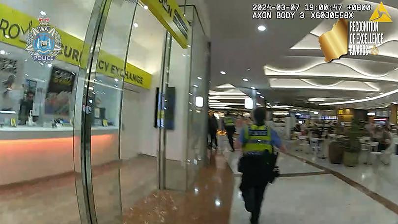 Police chase the man through the shops.