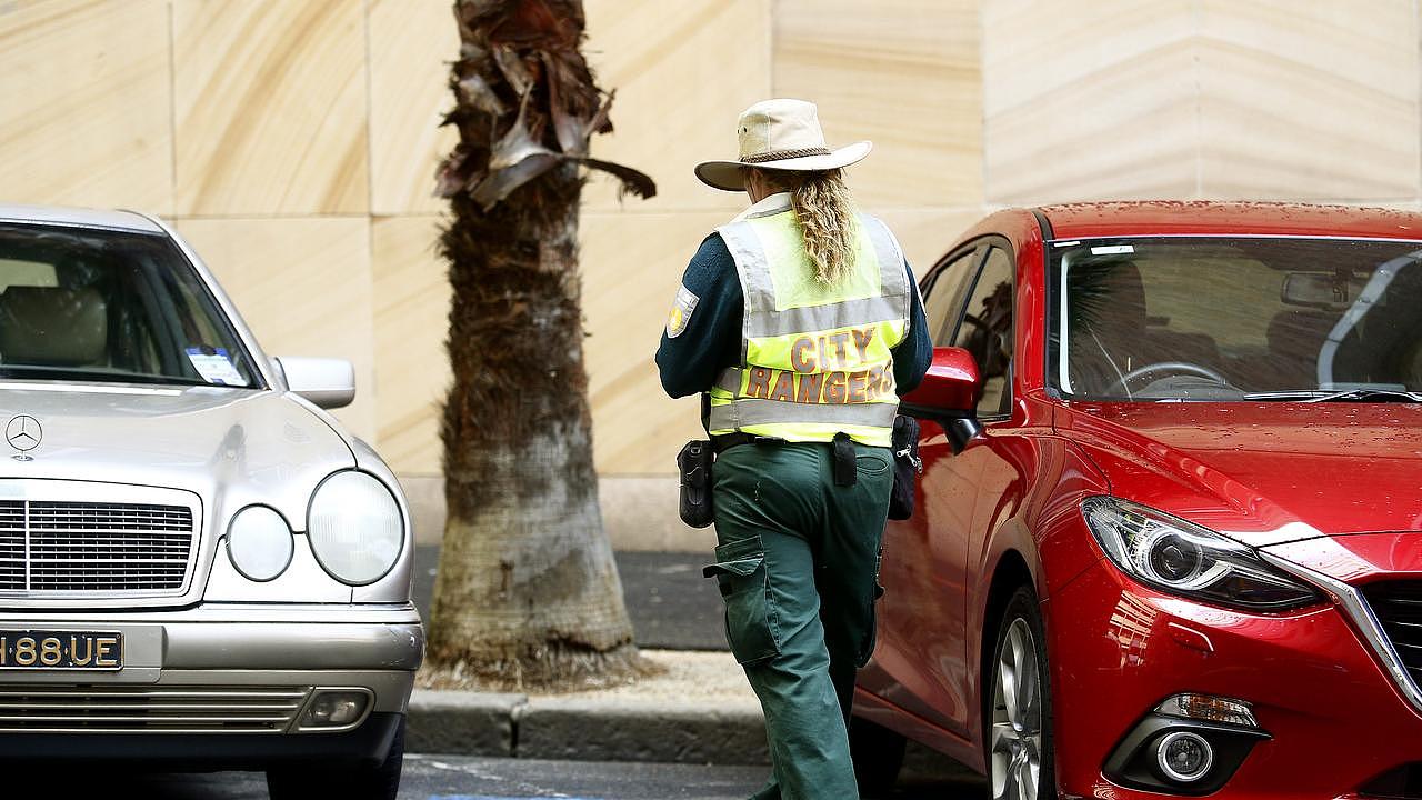 A City of Sydney Council Parking Ranger at work in the CBD. Picture: John Appleyard