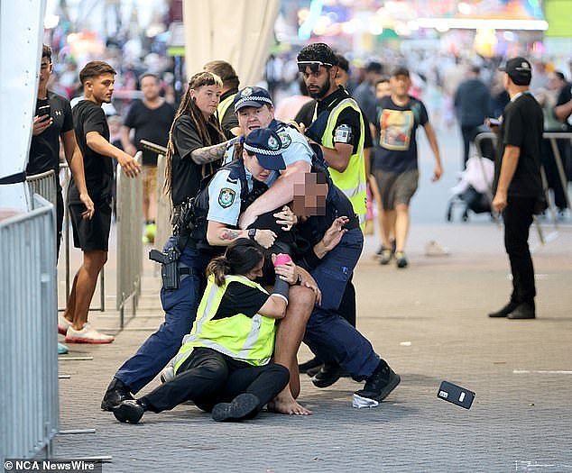 Shocking photos have captured the moment a young man was wrestled to the ground by police and security at the gates of the Sydney Royal Easter Show