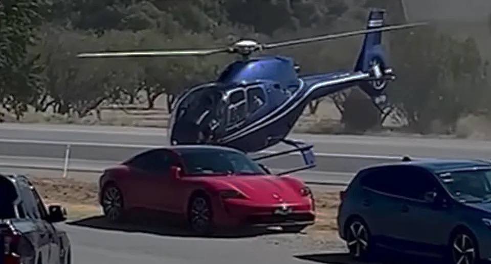 A helicopter seen here was filmed outside of the Victory Hotel in Sellicks Hill, south of Adelaide, attempted a strange stunt on Easter Sunday performing a bizarre stunt. 