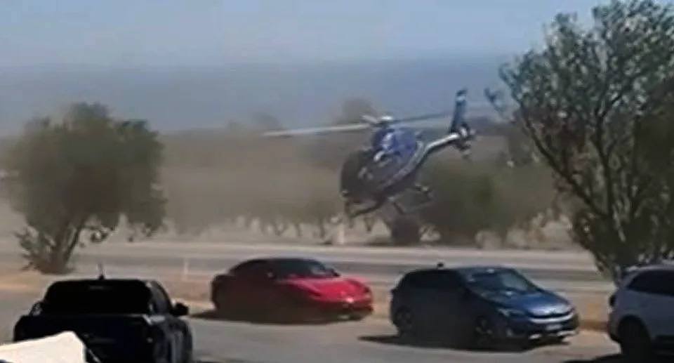 A helicopter seen here was filmed outside of the Victory Hotel in Sellicks Hill, south of Adelaide, attempted a strange stunt on Easter Sunday performing a bizarre stunt. 