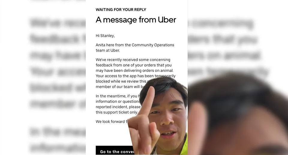 Stanley Chen points to the message he received on the app telling him he was banned. 