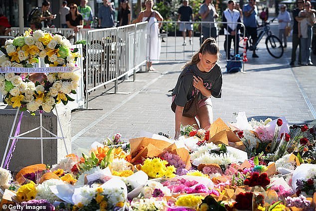A police source claims investigators believe Cauchi was 'definitely targeting women' (pictured, member of the public lays flowers as a tribute to the victims outside Oxford Street Mall)