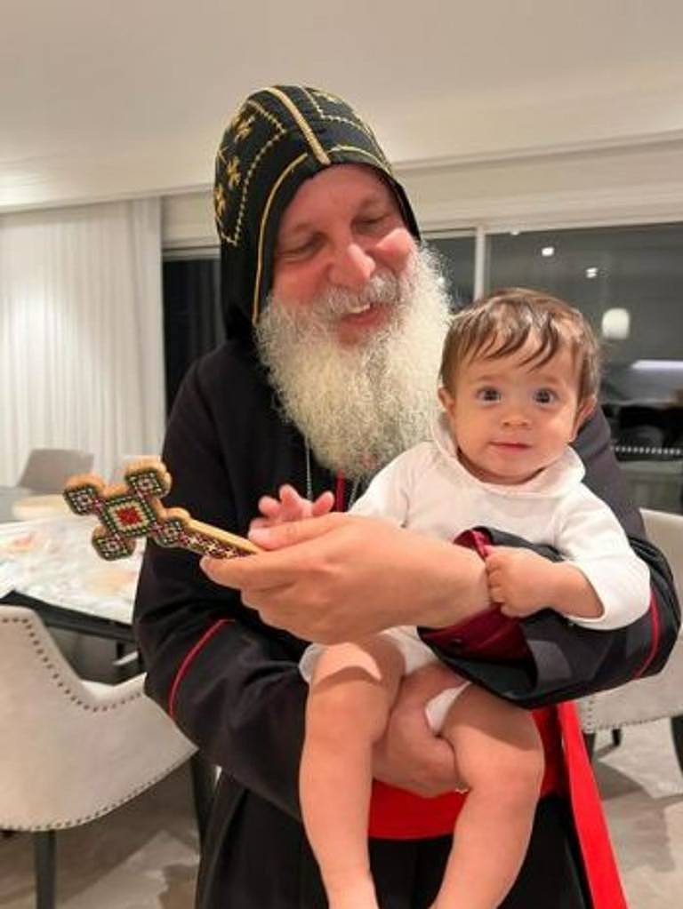 Bishop Mar Mari Emmanuel pictured with the youngest Abdallah child. Picture: Instagram