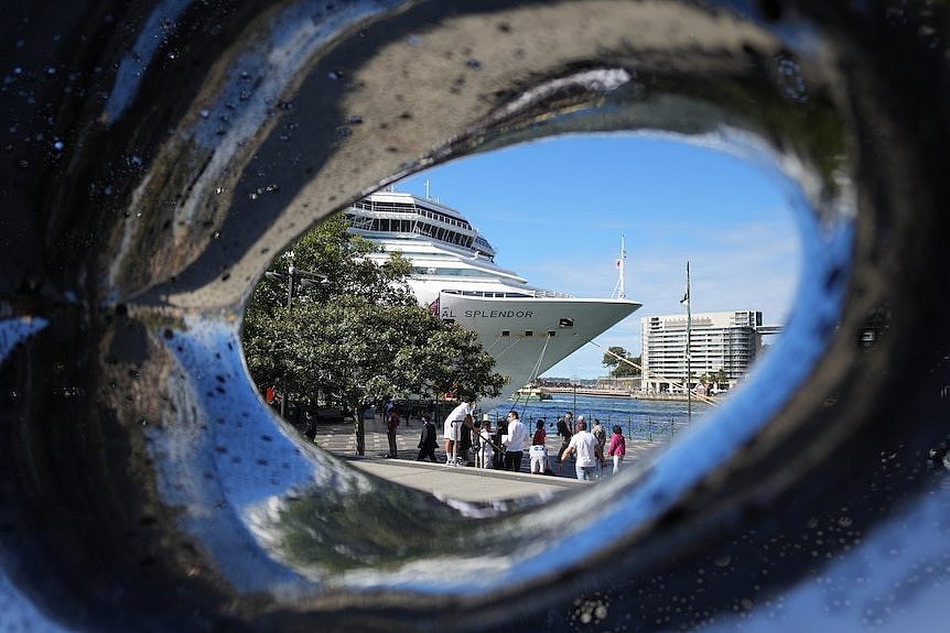 A cruise ship is seen in Sydney's Circular Quay through a hole in a sculpture