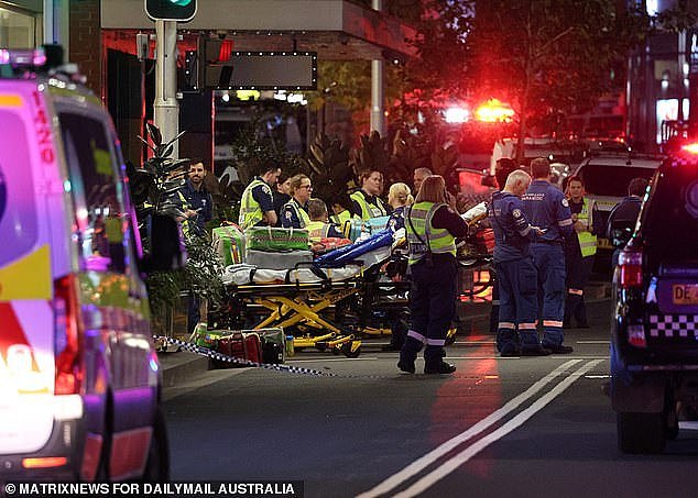 Eighteen people were stabbed by a lone knifeman at Westfield Bondi Junction in an attack that has left Sydney reeling (pictured: paramedics at the scene)