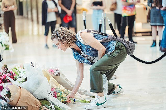 Australians were quick to react to her take on the day of reflection, with many advocating for the safety of retail staff at Bondi Junction (pictured, a woman leaves flowers at the memorial)