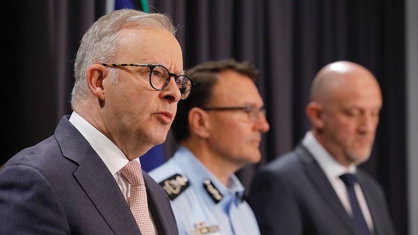 The PM speaking next to the AFP commissioner Reece Kershaw and ASIO boss Mike Burgess