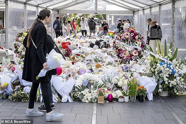 The Westfield Bondi Junction stabbing, which saw six innocent lives lost, shocked the whole of Australia (pictured, people leaving flowers at the memorial site)