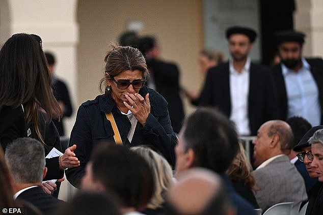 Crowds of young people were seen embracing and wiping away tears as the vigil got underway (pictured, a woman crying at the event)