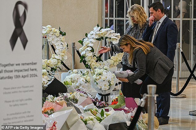 People lay flowers at a memorial set up inside the Bondi Junction Westfield Shopping Centre to honour the victims of Cauchi's stabbing rampage