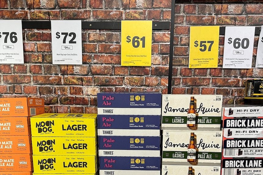 beer cartons next to eachother in different colours and brands