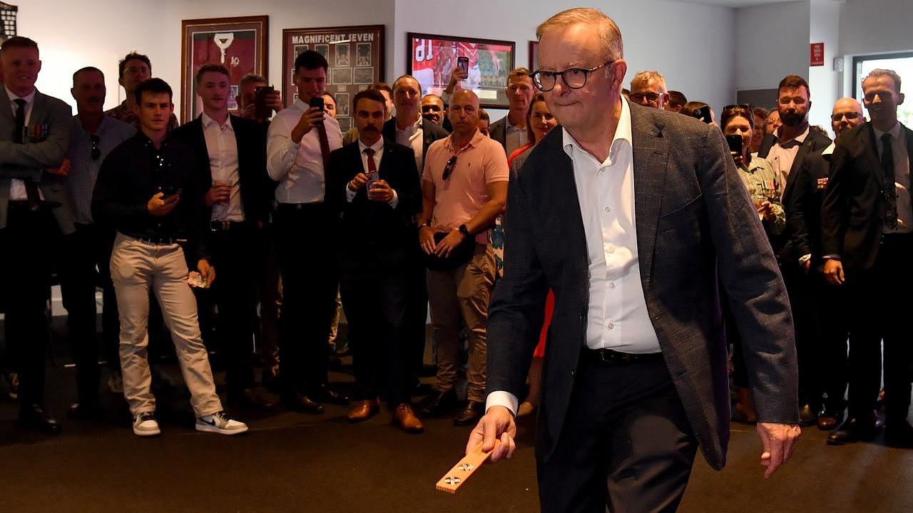 Prime Minister Anthony Albanese tosses the kip at two-up at Townsville RSL. Picture: Evan Morgan
