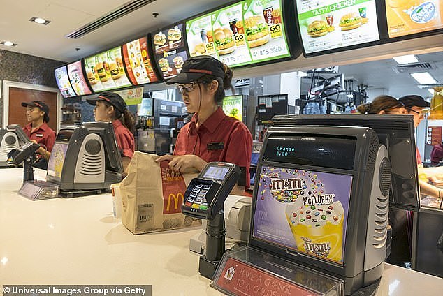 Workers employed by restaurants and fast food chains (pictured) have already been disrupted by AI technologies as the food services sector braces for more change