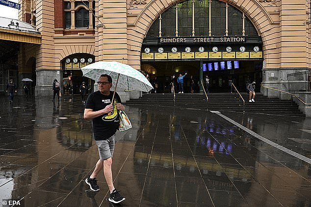 Melbourne is still a surprisingly affordable city for average-income borrowers looking to buy a house near the water and be a reasonable commute from the city (pictured is a man outside Flinders Street Station)
