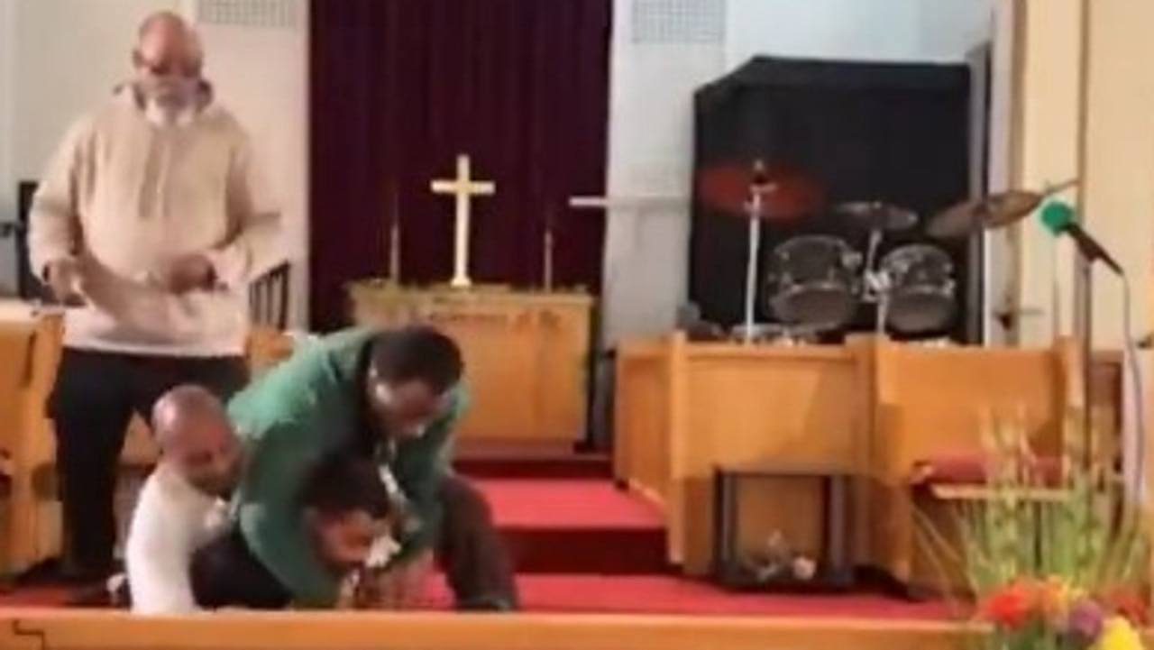 The pastor and bystander disarm the gunman. Picture: Supplied